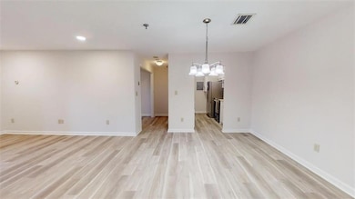 Empty room with light wood-type flooring, baseboar