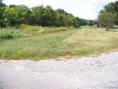 North east corner marker at edge of driveway of neighboring property. Looking straight back to the left of the shed and tree you can see the 400 ft. marker at the edge of the tree line.