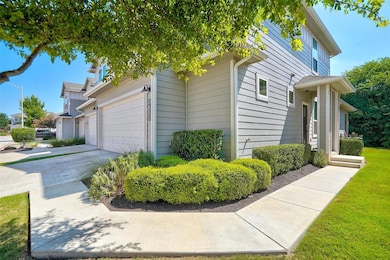 View of side of home with driveway, a garage, and