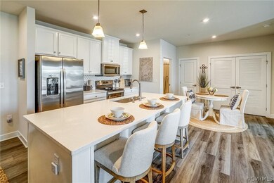 Kitchen with white cabinets, hanging light fixture