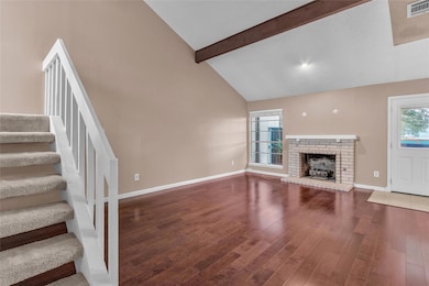 Unfurnished living room featuring beamed ceiling,