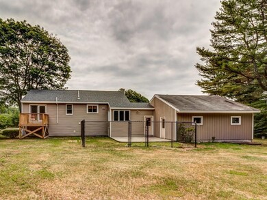Spacious back yard with a fenced in...