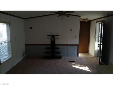 The living room features neutral decor, new carpet