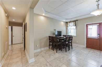 Dining space with light tile patterned floors, vis