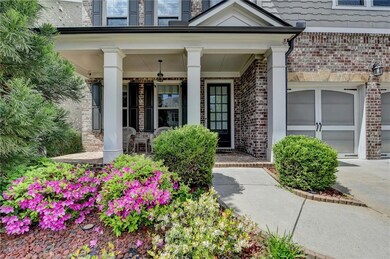 Property entrance featuring a porch and brick sidi