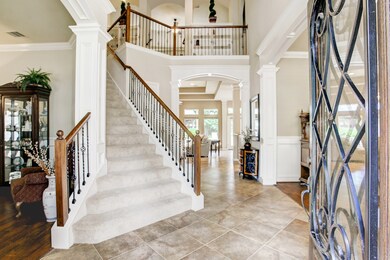 Beautiful grand 2 story entry with lots of custom wood work done around the doorways.  Don't miss the wainscoting on the dining room walls.