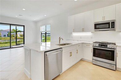 Kitchen featuring white cabinetry, kitchen peninsu