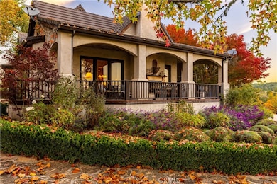 The captivating wraparound porch offers a charming first impression.