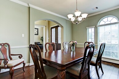 The dining room has arched window, crown molding, chair rail and a great space for your large family gatherings.