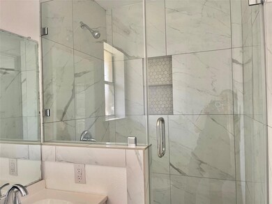 Full bath with a sink and a shower stall