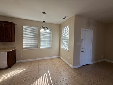 Unfurnished dining area featuring light tile patterned flooring and a chandelier