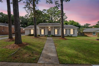 Neoclassical / greek revival house with a yard and a porch