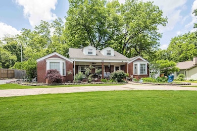View of front of property with brick siding and a porch