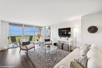 Living room with hardwood / wood-style flooring an