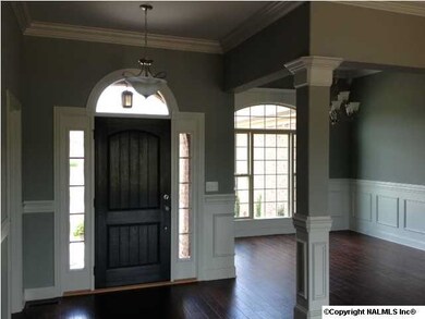 Enchanting foyer offers hardwood and crown molding. A beautiful front door boast sidelights with an arched glass accented the door. Foyer flows over to the dining room and great room with gleaming hardwood.
