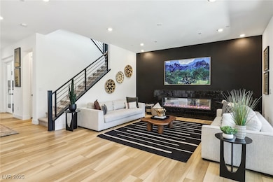 Living room featuring painted wallpaper accent wal