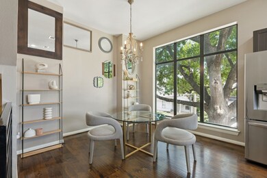 Dining space with dark wood-style floors and a chandelier