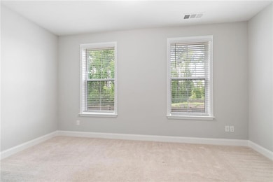 Terrace level bedroom with great view of the wooded area.