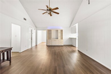 Unfurnished living room featuring high vaulted cei