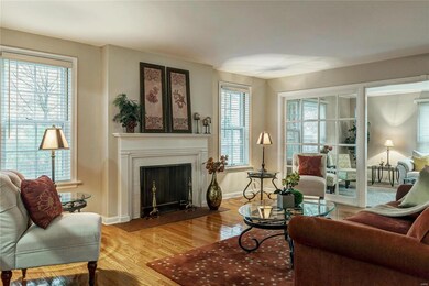 The spacious light-filled living room has gleaming