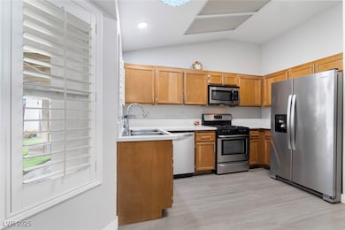 Kitchen with stainless steel appliances, a sink, l