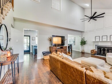 Living room with high vaulted ceiling, dark wood-type flooring, and ceiling fan