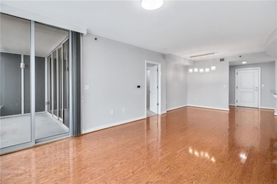 Unfurnished room featuring baseboards and wood finished floors