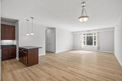 Bright and open floor plan welcomes you with natural light, stylish flooring, and a seamless flow from kitchen to living space