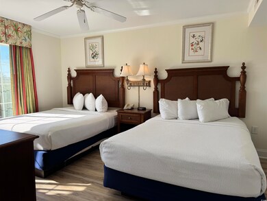Bedroom featuring a ceiling fan, crown molding, an