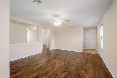 Spare room featuring dark wood finished floors, a