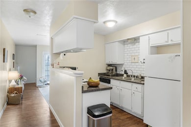 Kitchen featuring freestanding refrigerator, a sin