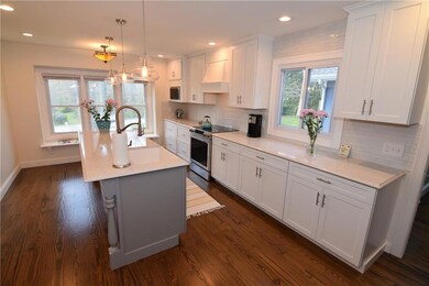 Huge kitchen with long center island, window seat