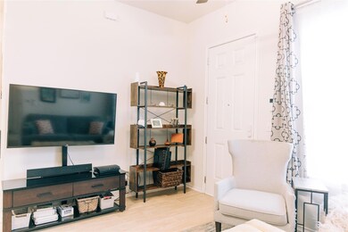 Living area with wood finished floors and ceiling