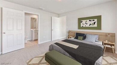 Carpeted bedroom with baseboards and connected bat