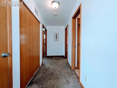 Hall with light carpet and baseboards