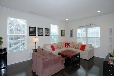 A very large living room boasts crown molding, a B