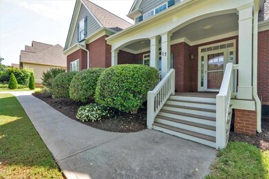 Doorway to property with brick siding and covered porch