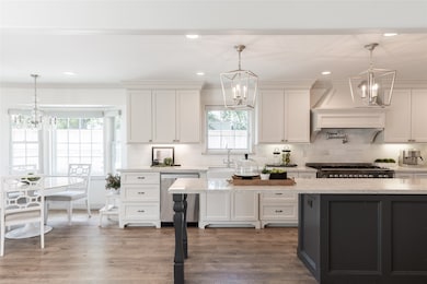 This bright, modern kitchen features white cabinet