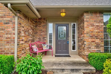 Front door with beautiful landscaping.
