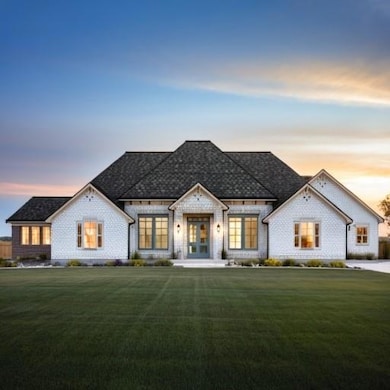 French provincial home featuring french doors, a front yard, and a shingled roof- Final Product may vary
