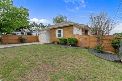 Single story home with driveway, a gate, a garage