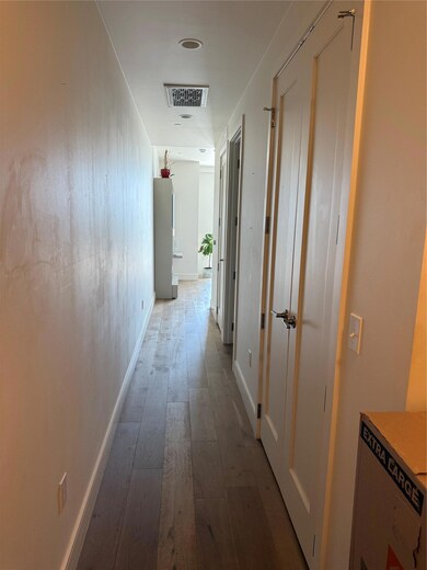 Hall with hardwood / wood-style flooring and base