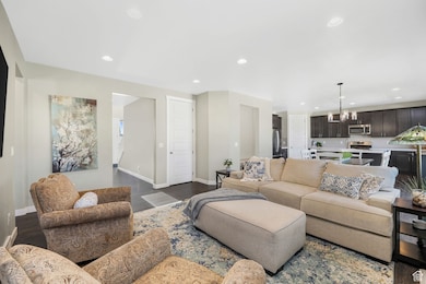Living room with recessed lighting, dark wood-type flooring