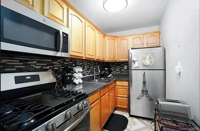 Kitchen featuring appliances with stainless steel finishes and decorative backsplash
