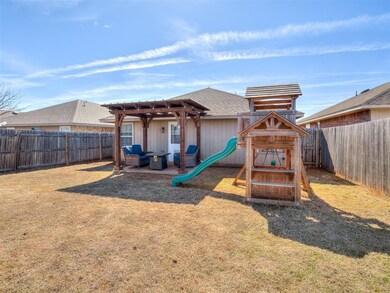 View of jungle gym featuring a lawn and a fenced b