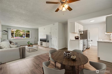 Open floor plan that easily flows into the kitchen. Photo virtually staged