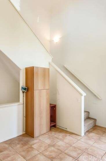 Stairs off the kitchen to the 3rd level bedroom.