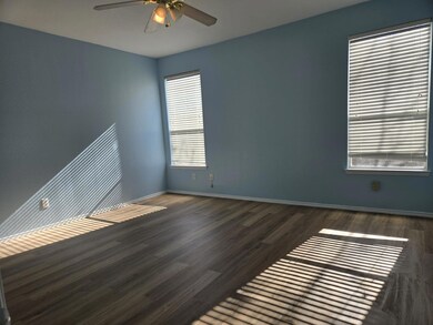 Spare room featuring ceiling fan and dark hardwood