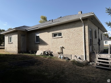 View of side of property with brick siding and a chimney