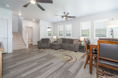Open floor plan living room with half bathroom dow